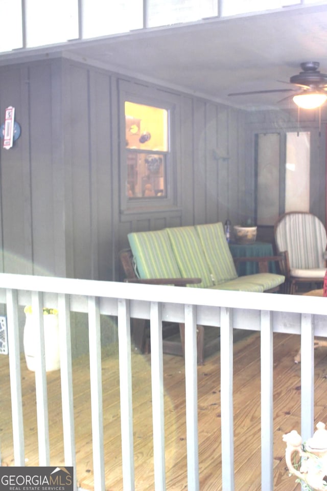 exterior space with ceiling fan and hardwood / wood-style floors