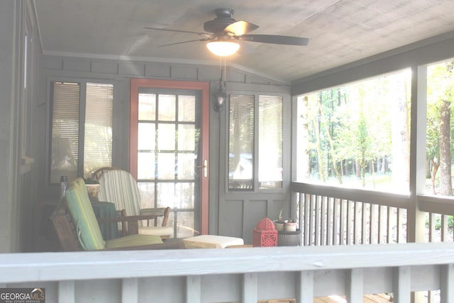 sunroom / solarium featuring lofted ceiling and ceiling fan