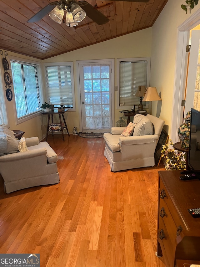 living room featuring light hardwood / wood-style flooring, wood ceiling, and a healthy amount of sunlight