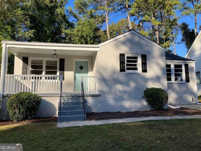 view of front of property with a front yard and a porch