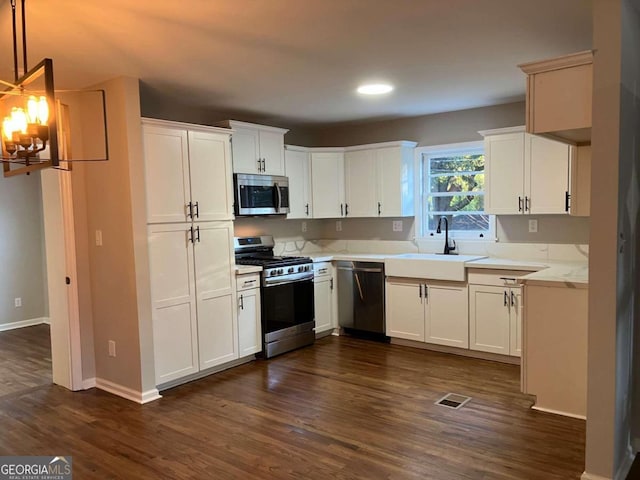 kitchen featuring appliances with stainless steel finishes, white cabinets, and dark hardwood / wood-style flooring