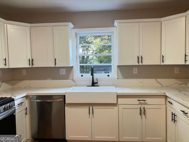 kitchen with dishwasher, white cabinets, sink, and light stone counters