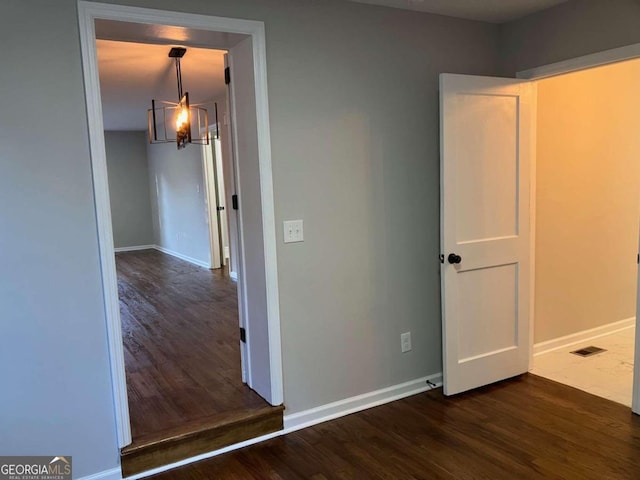 interior space featuring a notable chandelier and dark hardwood / wood-style floors