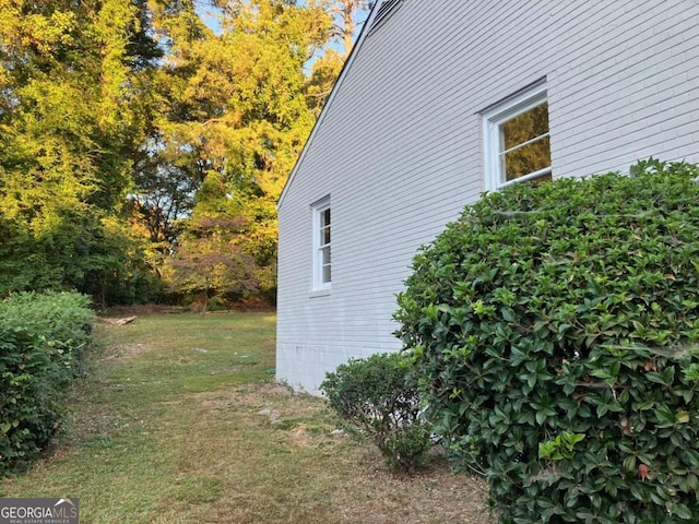 view of home's exterior with a lawn