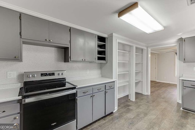 kitchen with gray cabinetry, stainless steel electric range, and light hardwood / wood-style flooring