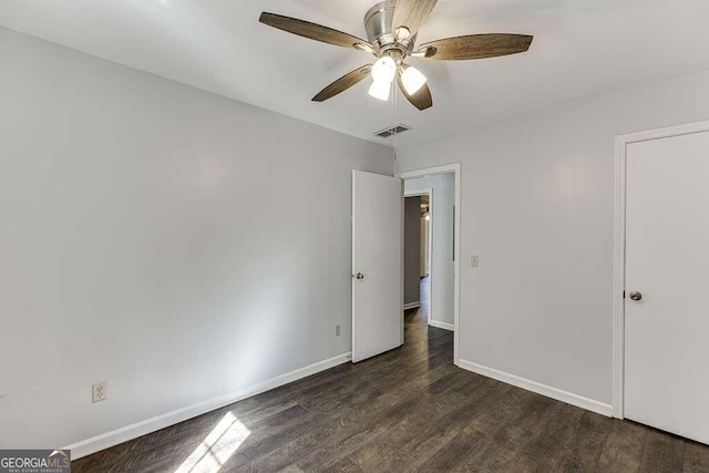 unfurnished bedroom with dark hardwood / wood-style floors and ceiling fan