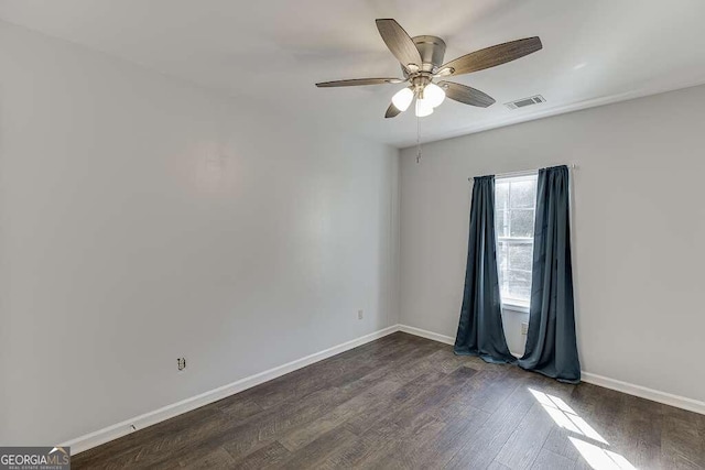 unfurnished room featuring ceiling fan and dark hardwood / wood-style floors