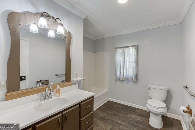 bathroom featuring toilet, crown molding, hardwood / wood-style flooring, and vanity