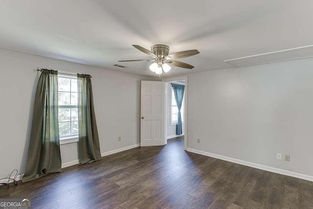 spare room with ceiling fan and dark hardwood / wood-style flooring