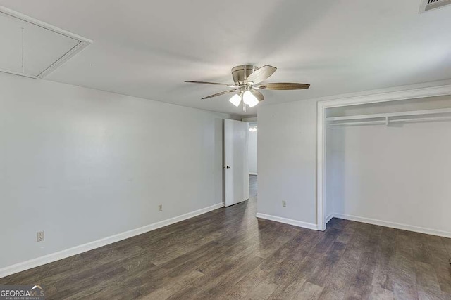 unfurnished bedroom with dark hardwood / wood-style floors, a closet, and ceiling fan