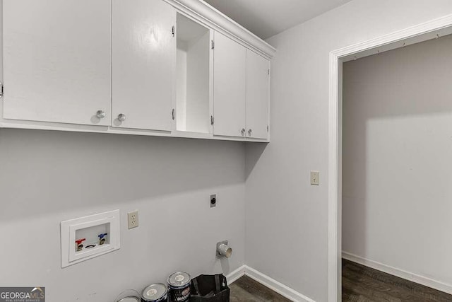 clothes washing area with hookup for an electric dryer, gas dryer hookup, washer hookup, cabinets, and dark hardwood / wood-style floors