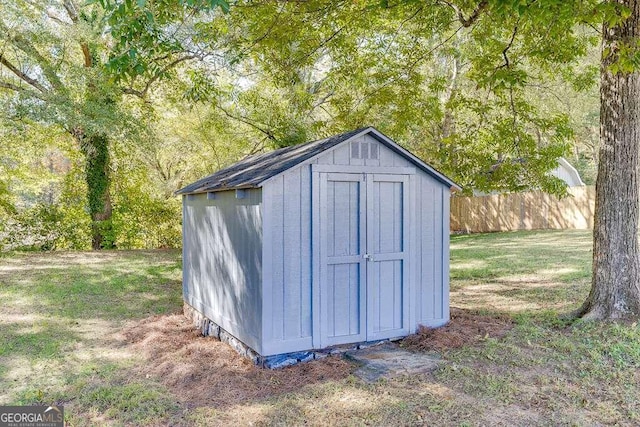 view of outbuilding featuring a yard