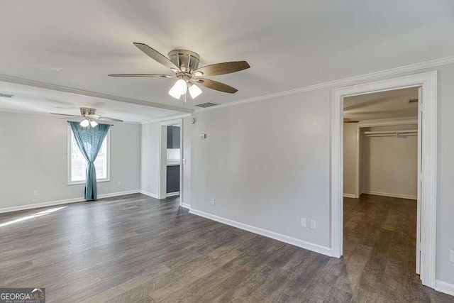 interior space with dark wood-type flooring, ceiling fan, crown molding, and a closet