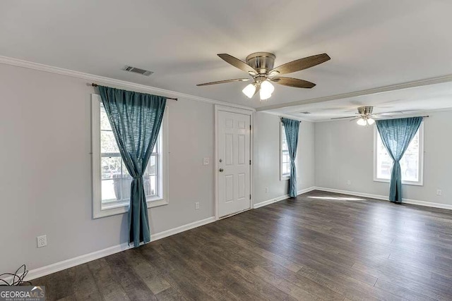 empty room with ornamental molding, ceiling fan, and dark hardwood / wood-style floors