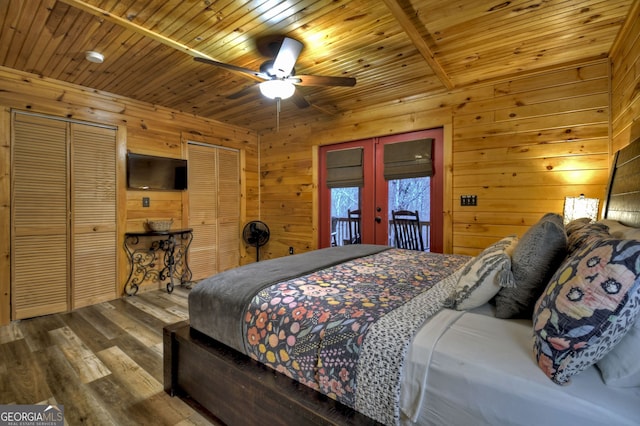 bedroom featuring ceiling fan, french doors, hardwood / wood-style floors, wooden walls, and wood ceiling