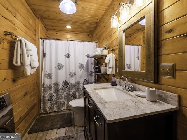 bathroom with wooden ceiling, wood walls, wood-type flooring, toilet, and vanity