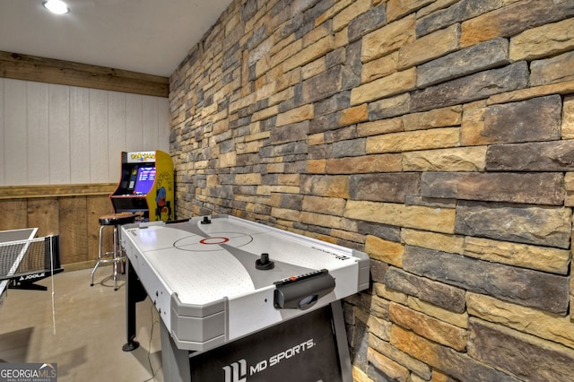 recreation room with wood walls