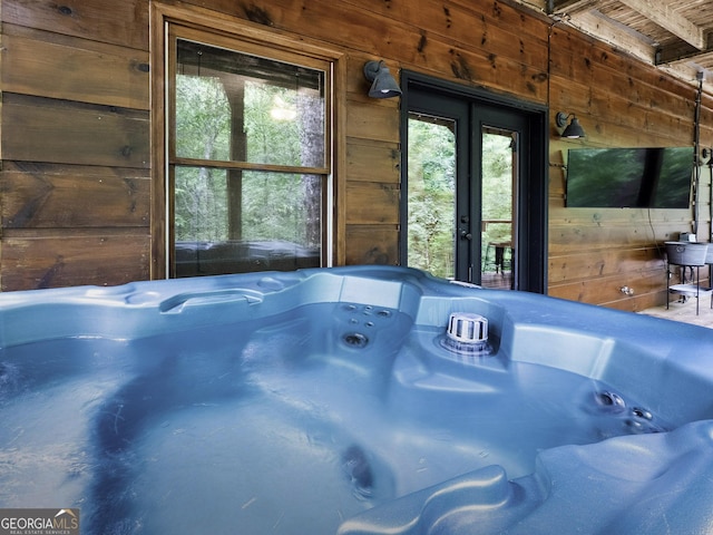 room details featuring wooden walls and a hot tub