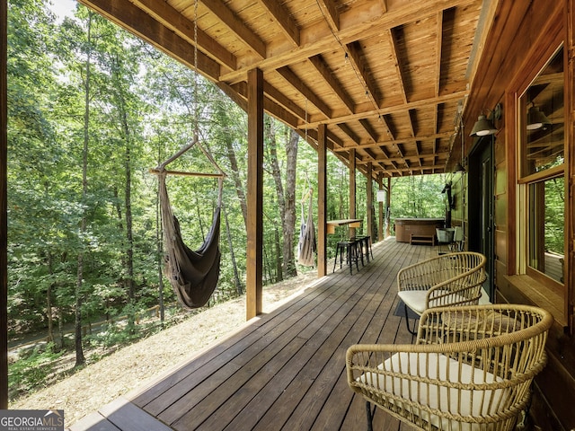 wooden terrace with a hot tub