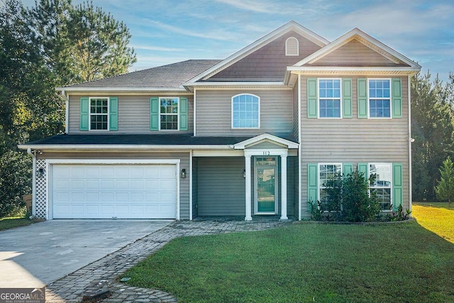 view of front of house with a garage and a front lawn