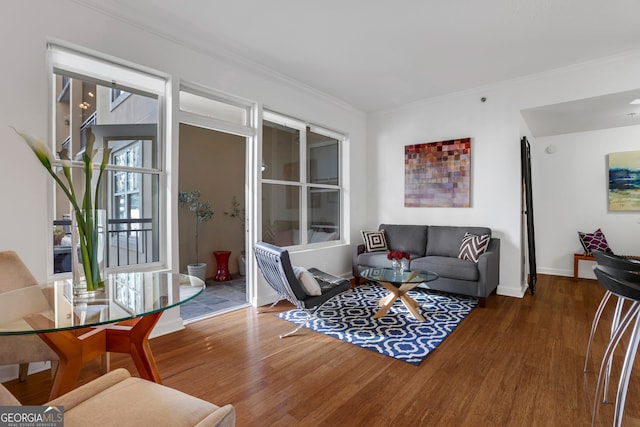 living room with crown molding, a healthy amount of sunlight, and dark hardwood / wood-style floors