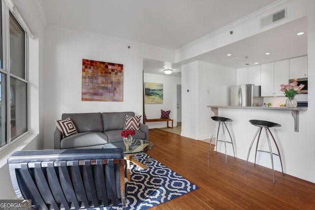 living room featuring crown molding and wood-type flooring