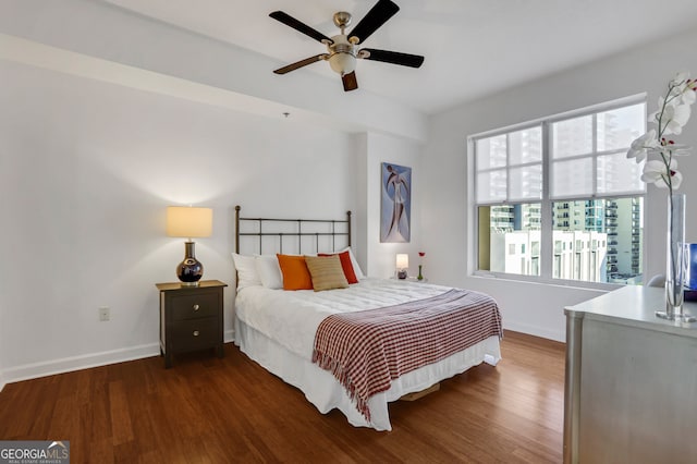 bedroom featuring ceiling fan and dark hardwood / wood-style floors