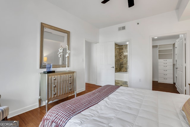 bedroom featuring a spacious closet, hardwood / wood-style floors, a closet, and ceiling fan