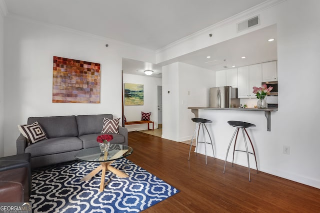 living room featuring crown molding and dark hardwood / wood-style floors