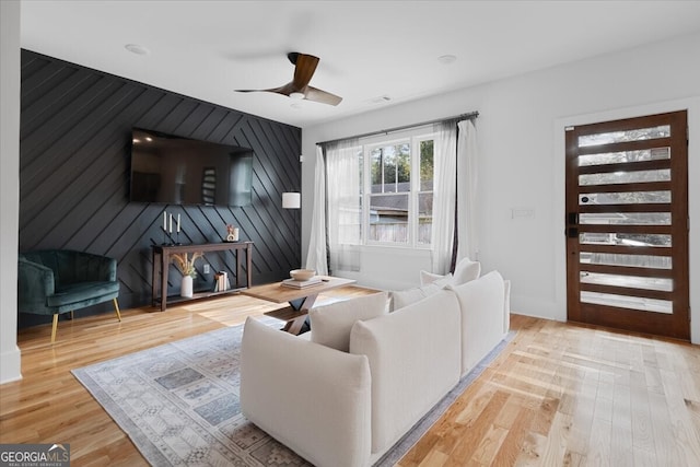 living room with ceiling fan and light wood-type flooring