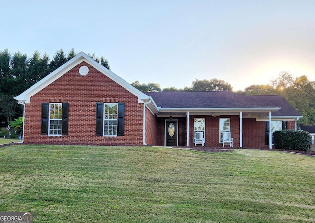 view of front of property featuring a porch and a lawn