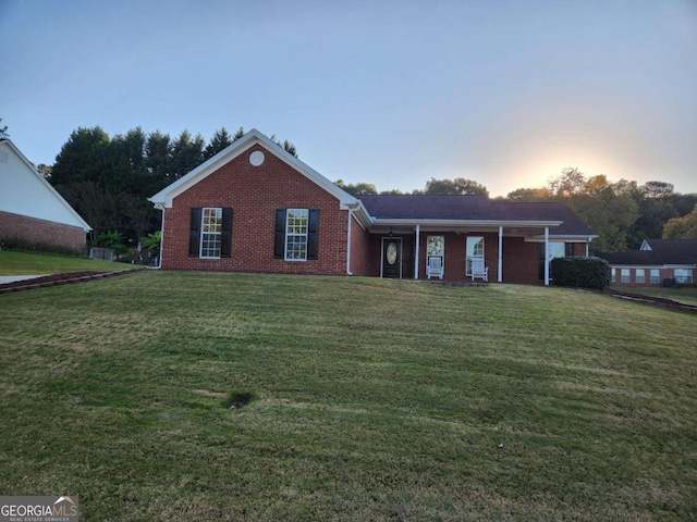 ranch-style home with a lawn