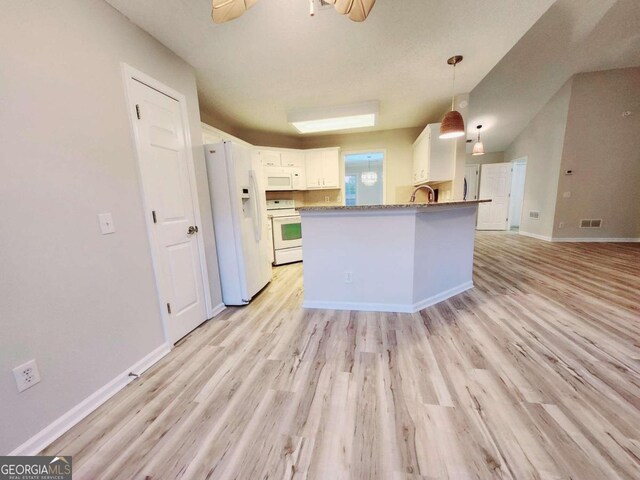 kitchen with white appliances, hanging light fixtures, light hardwood / wood-style flooring, and white cabinets