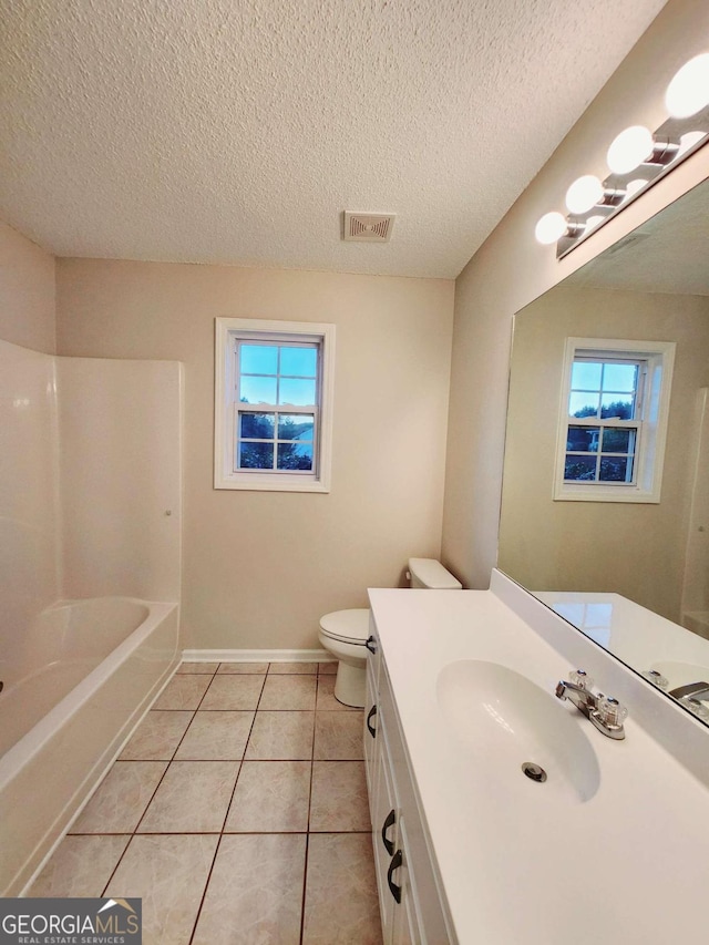 full bathroom with vanity, toilet, a wealth of natural light, and tile patterned flooring