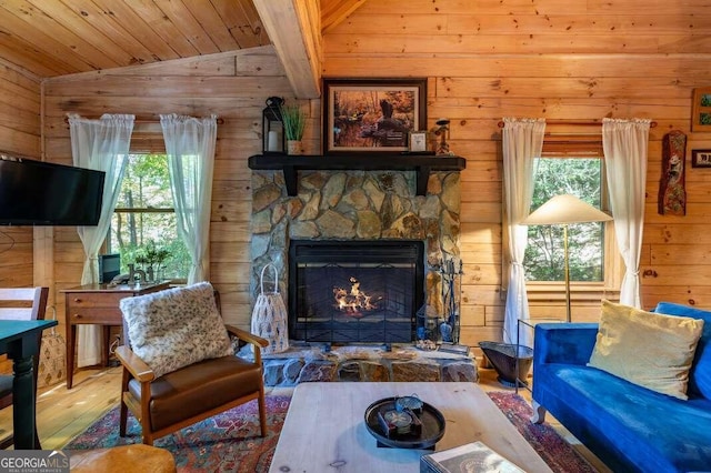 living room with a healthy amount of sunlight, wood-type flooring, lofted ceiling, and a fireplace