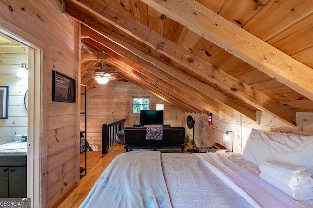 bedroom with lofted ceiling with beams, wooden walls, wood ceiling, and wood finished floors