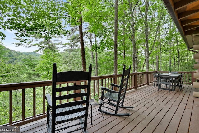 wooden terrace featuring outdoor dining area