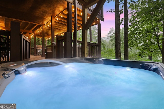 view of swimming pool with a deck and a hot tub