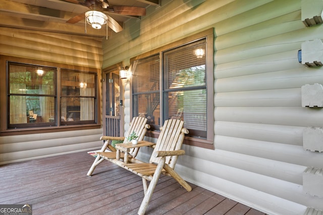 wooden deck with covered porch and a ceiling fan