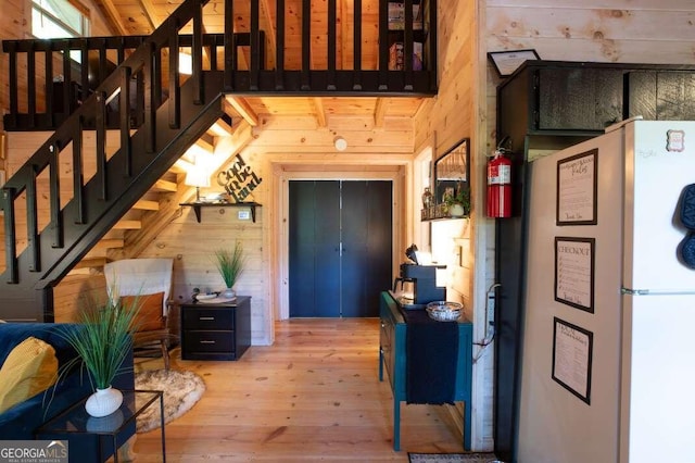 interior space featuring stairs, wood finished floors, and wood walls