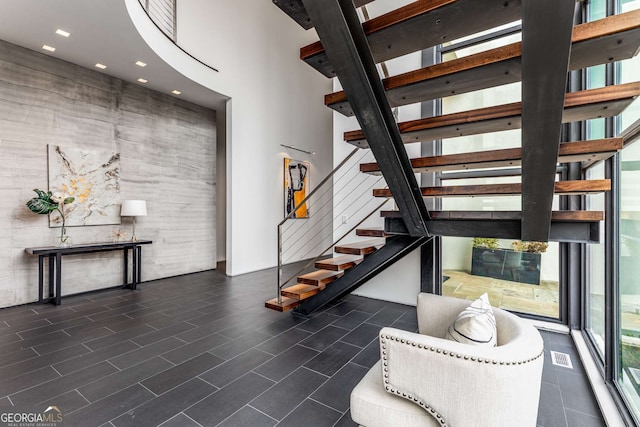 interior space featuring a high ceiling and visible vents