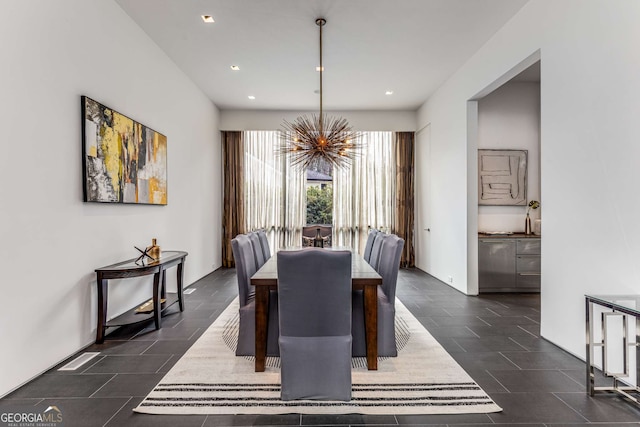 dining room with recessed lighting and an inviting chandelier