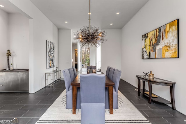 dining area featuring recessed lighting, dark tile patterned flooring, and an inviting chandelier