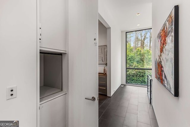 interior space featuring dark tile patterned floors and floor to ceiling windows