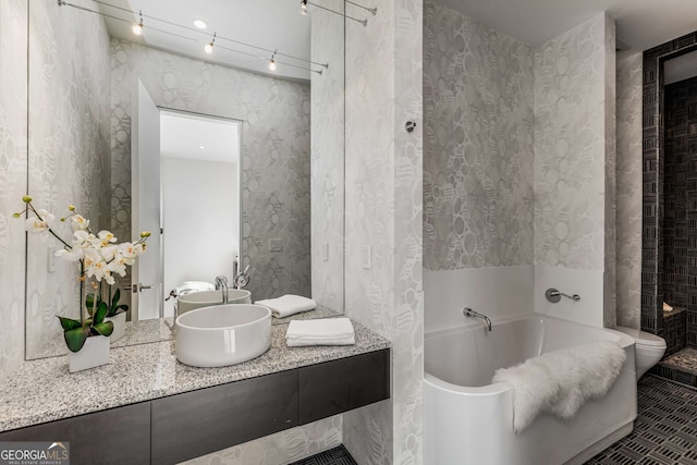 full bath featuring a tub to relax in, wallpapered walls, toilet, and vanity