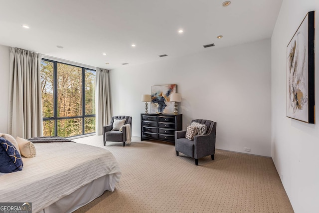 bedroom with light colored carpet, visible vents, and recessed lighting