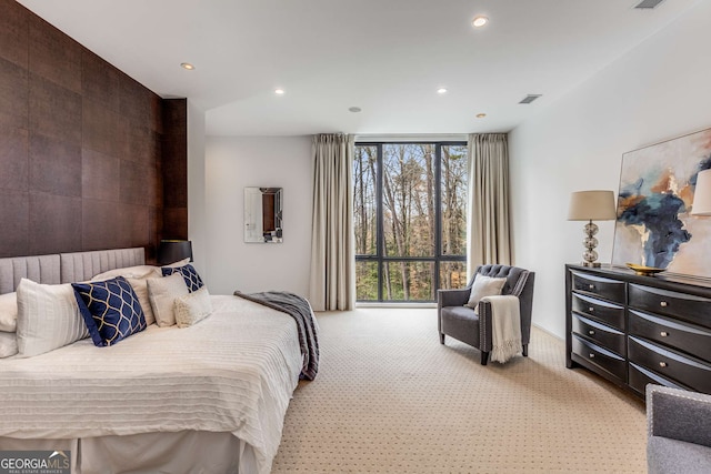 carpeted bedroom with expansive windows and recessed lighting