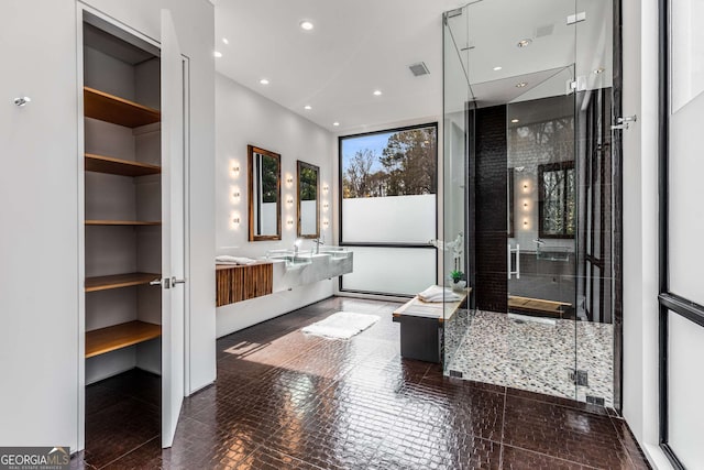 bathroom featuring recessed lighting, visible vents, a shower stall, and vanity