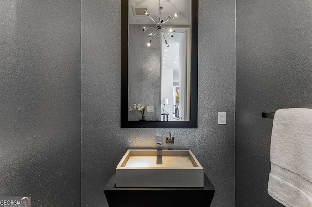 bathroom featuring vanity and a notable chandelier