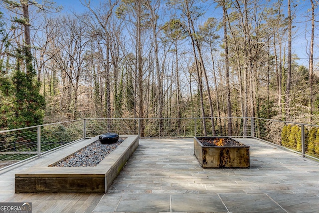 wooden deck featuring an outdoor fire pit